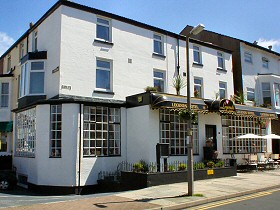 Exterior photograph of Legends Hotel showing view from the hotel with it's black and white paintwork